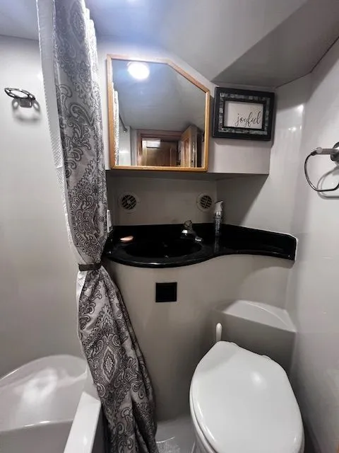 Slide: The Image of Bathroom in 1997 Bluewater Yachts 510 with shower and toilet. - 12