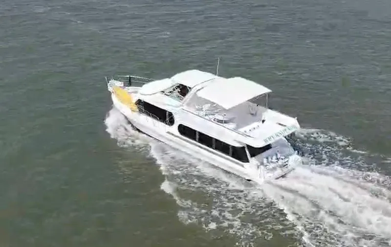 Slide: The Image of 1997 Bluewater Yachts 510 cruising on open water. - 3