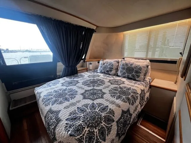 Slide: The Image of Interior of a 1997 Bluewater Yachts 510 with cozy bedroom. - 4