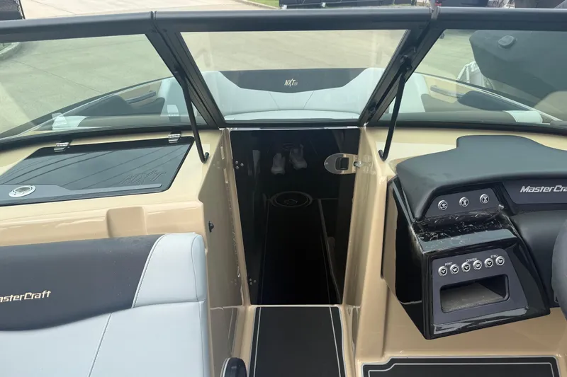 Slide: The Image of Interior view of 2025 MasterCraft NXT24 boat, showcasing dashboard and seating area. - 13