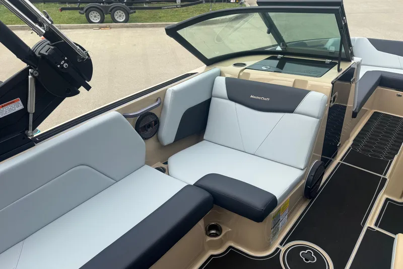 Slide: The Image of 2025 MasterCraft NXT24 boat interior with sleek seating and modern design. - 16