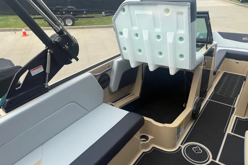 Slide: The Image of 2025 MasterCraft NXT24 boat interior with open storage compartment and seating. - 17