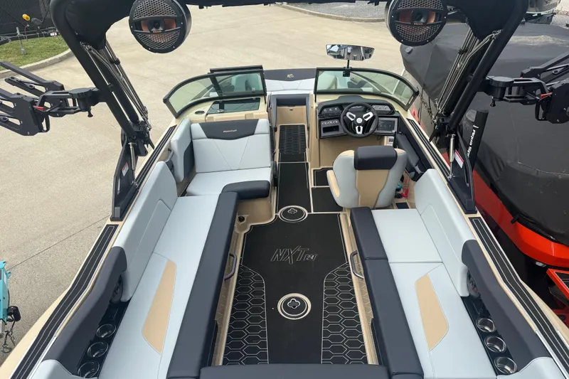 Slide: The Image of 2025 MasterCraft NXT24 boat interior with modern seating and advanced dashboard features. - 22