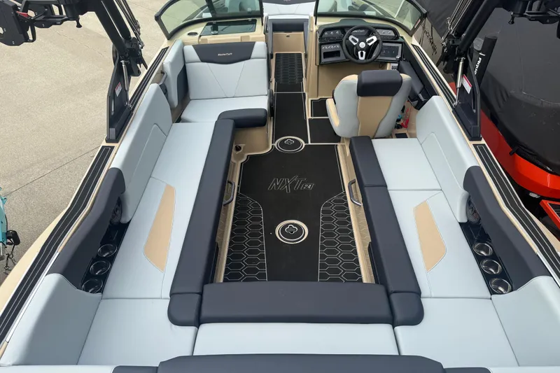 Slide: The Image of 2025 MasterCraft NXT24 boat interior with spacious seating and modern dashboard design. - 23