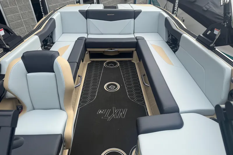 Slide: The Image of 2025 MasterCraft NXT24 boat interior with sleek seating and modern design. - 4