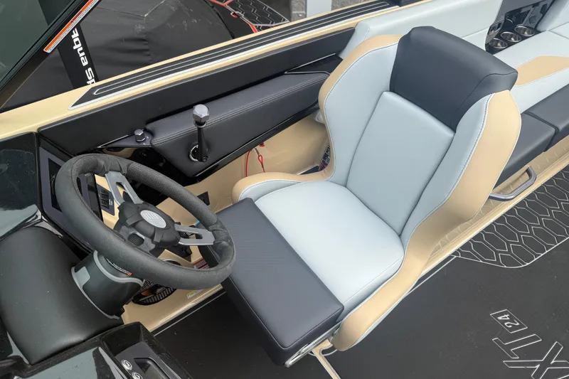 Slide: The Image of 2025 MasterCraft NXT24 boat interior with modern steering and comfortable seating. - 5