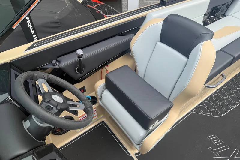 Slide: The Image of 2025 MasterCraft NXT24 boat interior with steering wheel and modern seating design. - 6