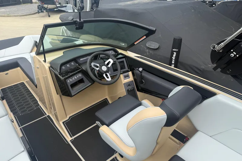 Slide: The Image of 2025 MasterCraft NXT24 boat interior with modern steering and seating design. - 7