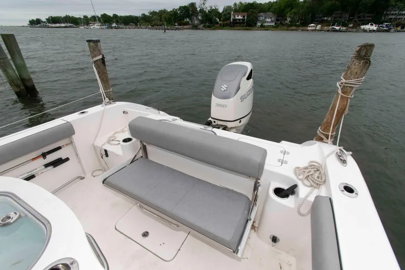 Slide: The Image of 2021 Sea Pro 259 Center Console boat with Suzuki engine, docked by the water. - 10