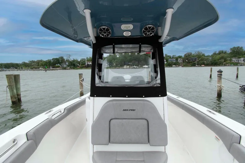 Slide: The Image of 2021 Sea Pro 259 Center Console boat on calm water, showcasing seating and helm. - 12