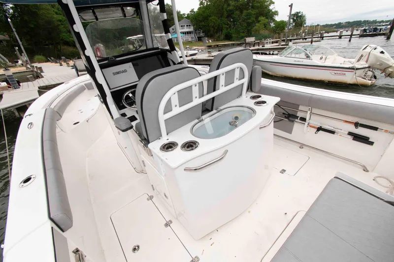 Slide: The Image of 2021 Sea Pro 259 Center Console boat interior with seating and fishing equipment. - 13