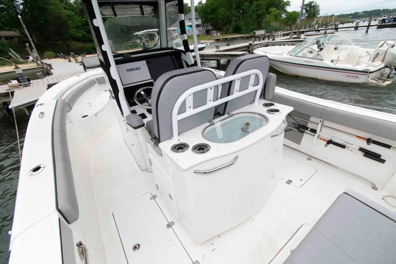 Slide: The Image of 2021 Sea Pro 259 Center Console boat interior with seating and fishing rod holders. - 14