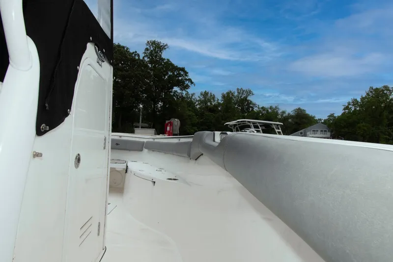 Slide: The Image of 2021 Sea Pro 259 Center Console boat deck with clear sky and trees in background. - 15