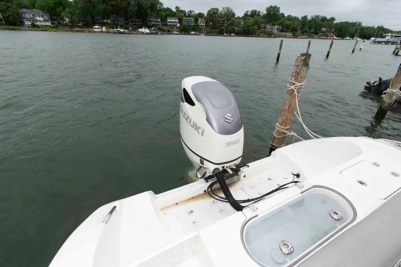 Slide: The Image of 2021 Sea Pro 259 Center Console with Suzuki 350 outboard motor docked by the shore. - 17