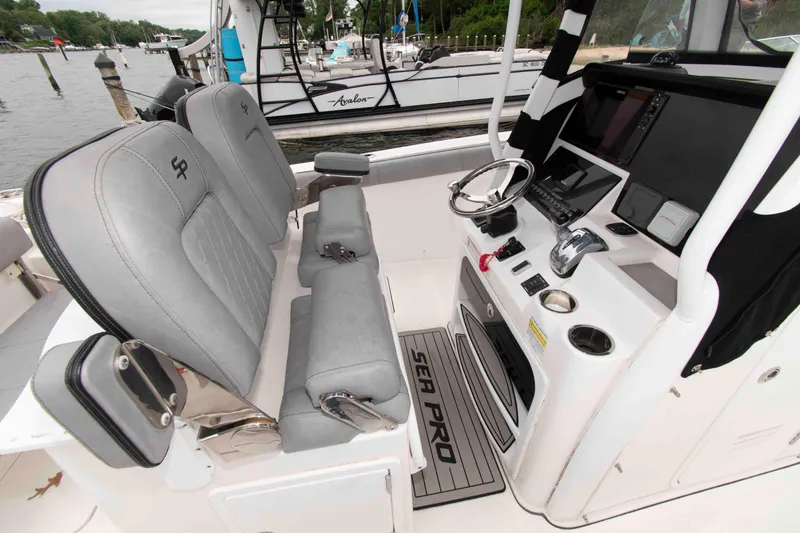 Slide: The Image of 2021 Sea Pro 259 Center Console boat interior with helm and seating. - 4