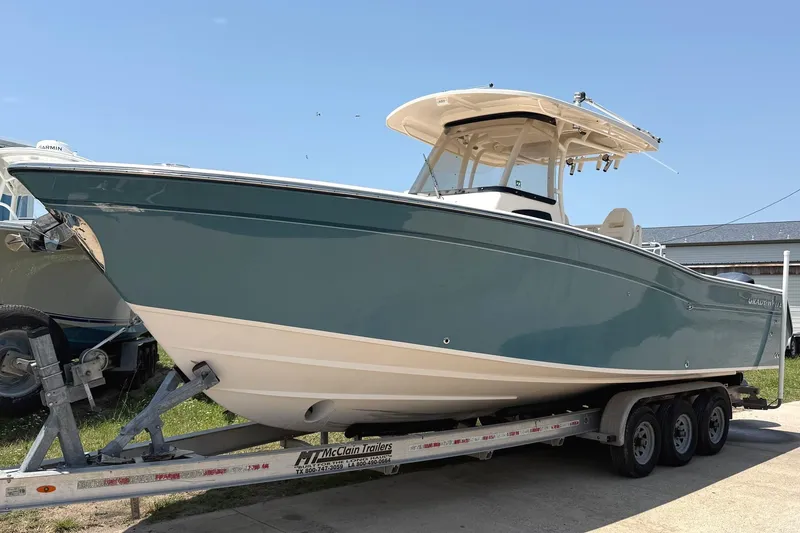 The Image of 2018 Grady-White Canyon 306 boat on trailer, side view under clear sky. - 0