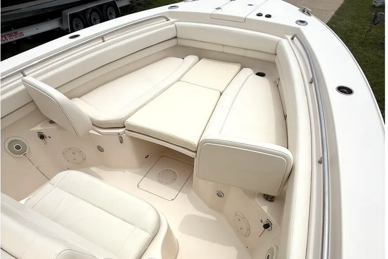 Slide: The Image of 2018 Grady-White Canyon 306 boat interior with white cushioned seating. - 13