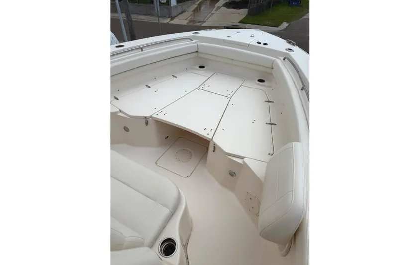 Slide: The Image of 2018 Grady-White Canyon 306 boat interior with white seating and storage compartments. - 15
