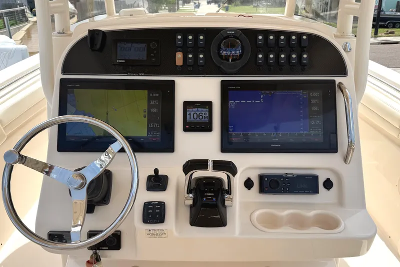 Slide: The Image of 2018 Grady-White Canyon 306 helm with dual Garmin displays and Yamaha controls. - 19