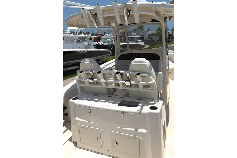 Slide: The Image of 2018 Grady-White Canyon 306 boat interior with rod holders and seating. - 23