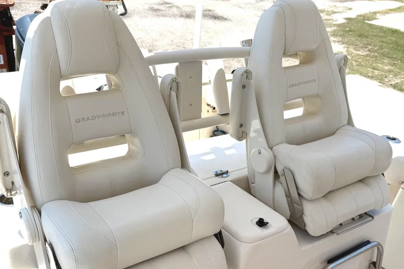 Slide: The Image of 2018 Grady-White Canyon 306 boat seats, featuring luxurious white leather upholstery. - 24