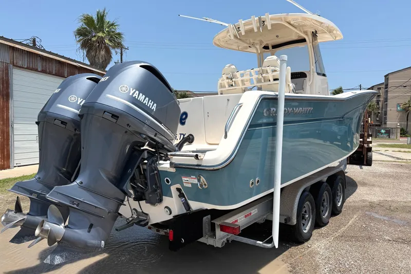 Slide: The Image of 2018 Grady-White Canyon 306 boat with dual Yamaha engines on a trailer. - 3