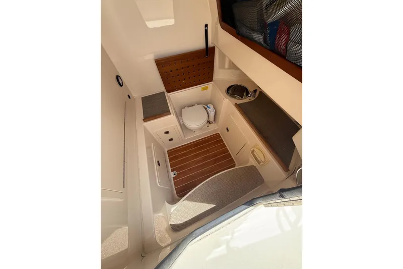 Slide: The Image of 2018 Grady-White Canyon 306 boat interior with toilet and sink. - 30