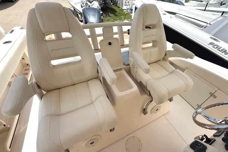 Slide: The Image of 2018 Grady-White Canyon 306 boat seats, featuring luxurious white leather upholstery. - 32