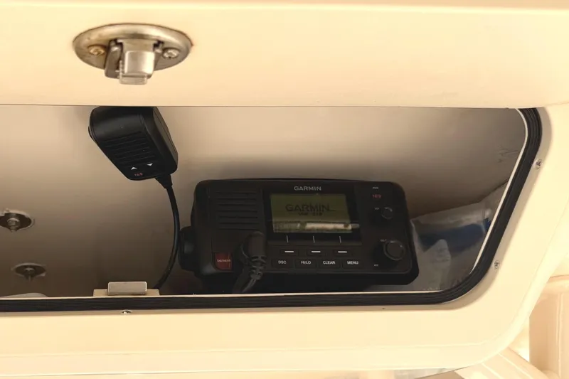 Slide: The Image of Garmin radio system inside 2018 Grady-White Canyon 306 boat compartment. - 33