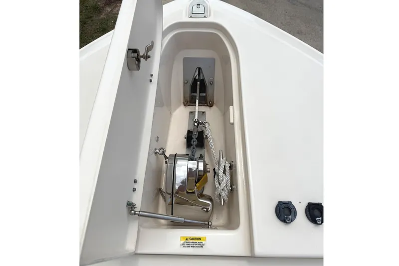 Slide: The Image of Anchor compartment of 2018 Grady-White Canyon 306 boat, featuring winch and rope storage. - 40