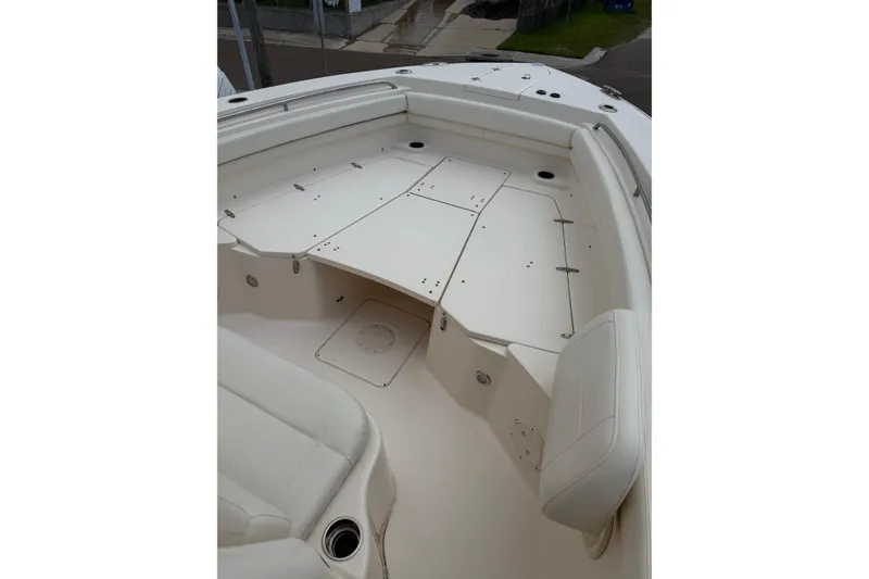 Slide: The Image of 2018 Grady-White Canyon 306 boat interior with white seating and storage compartments. - 41
