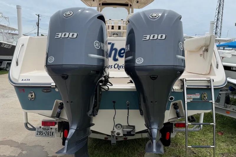 Slide: The Image of 2018 Grady-White Canyon 306 boat with twin Yamaha 300 engines, docked outdoors. - 5