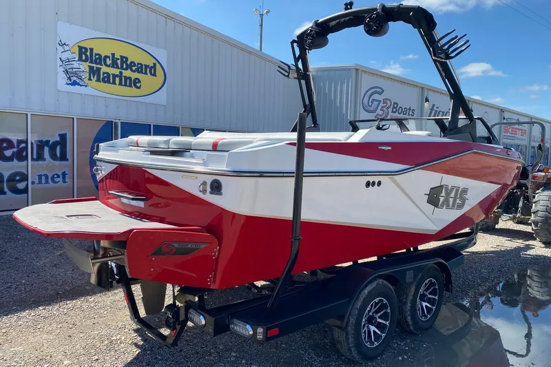Slide: The Image of 2023 Axis T220 boat in red and white at BlackBeard Marine dealership. - 6