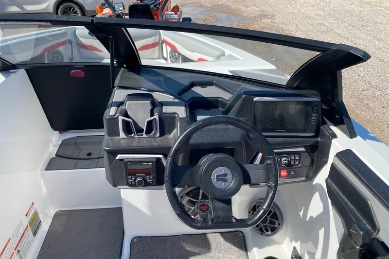 Slide: The Image of 2023 Axis T220 boat dashboard with steering wheel and navigation controls. - 8