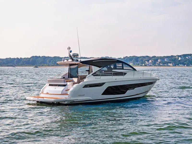Slide: The Image of 2025 Fairline Targa 50 GT yacht cruising on a serene coastal waterway. - 13