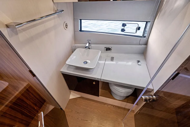 Slide: The Image of Luxurious bathroom in 2025 Fairline Targa 50 GT yacht with modern sink and window view. - 48