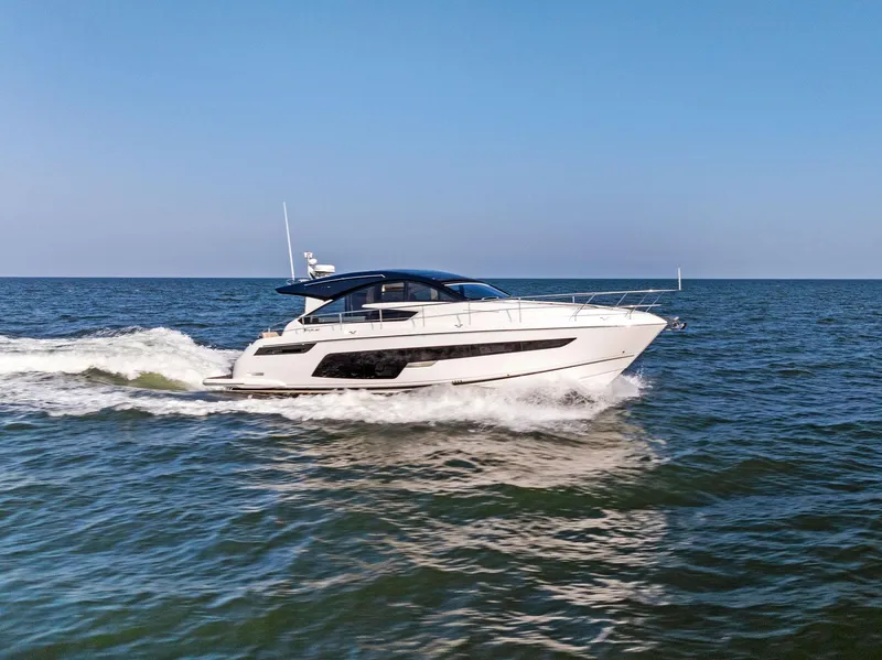 Slide: The Image of 2025 Fairline Targa 50 GT yacht cruising on open sea under clear blue sky. - 6