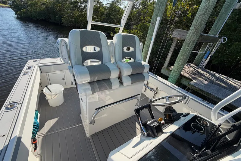 Slide: The Image of 2002 Regulator 26 Center Console boat interior with helm and seating area. - 10