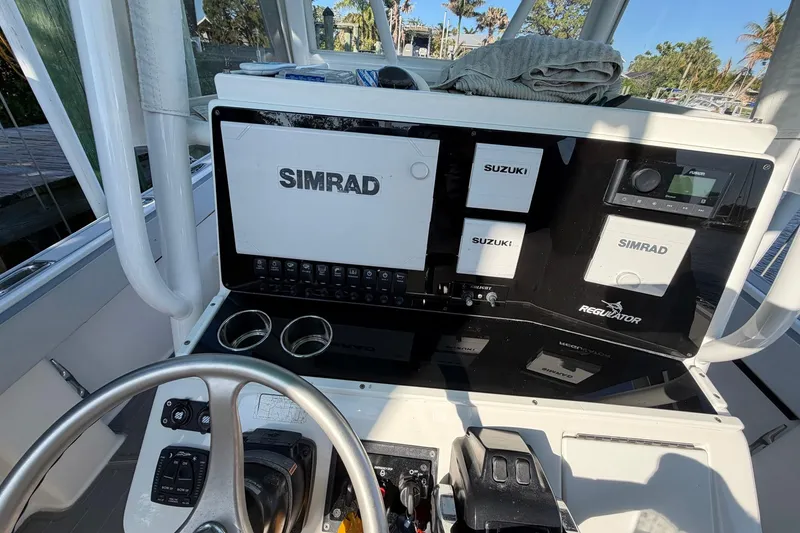 Slide: The Image of Center console of a 2002 Regulator 26 boat with Simrad and Suzuki electronics. - 13