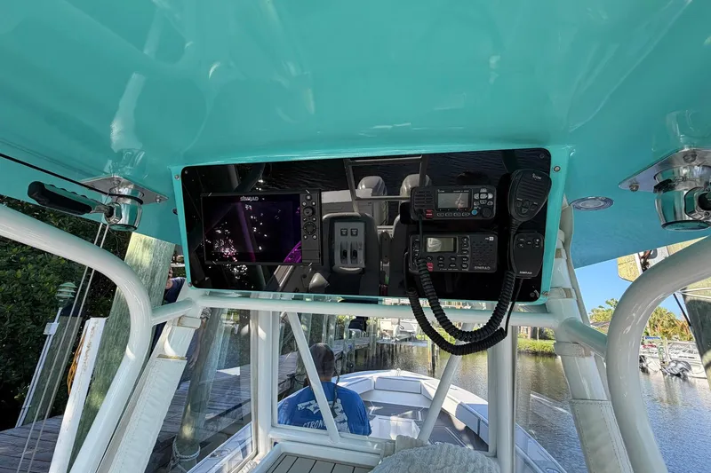 Slide: The Image of 2002 Regulator 26 Center Console boat dashboard with navigation and communication equipment. - 16
