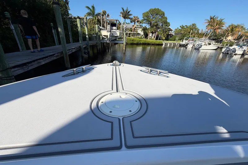 Slide: The Image of Bow view of a 2002 Regulator 26 Center Console boat docked in a marina. - 6