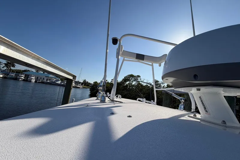 Slide: The Image of 2002 Regulator 26 Center Console boat docked under clear blue sky. - 8