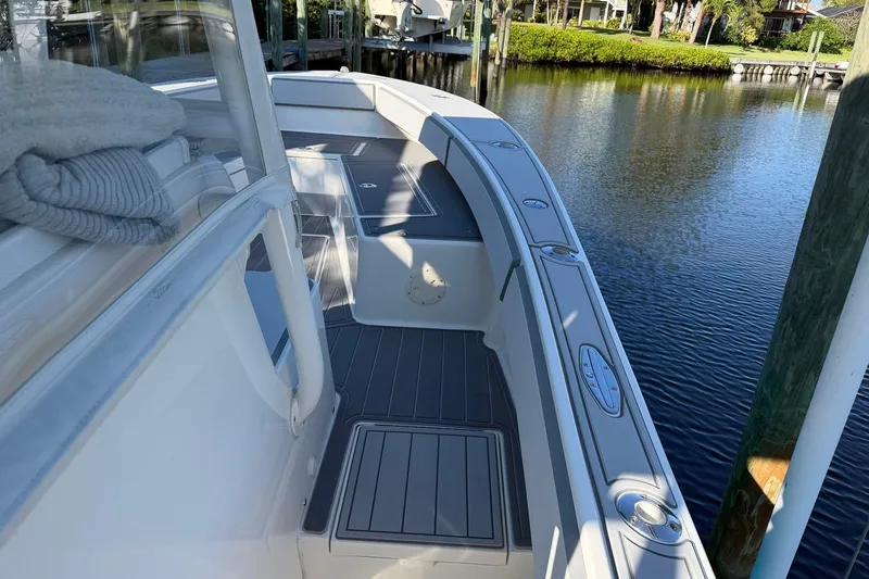 Slide: The Image of 2002 Regulator 26 Center Console boat docked by calm waters. - 9