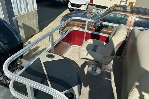Slide: The Image of 2025 Sun Tracker Bass Buggy 18 DLX pontoon boat interior with seating and railing. - 10