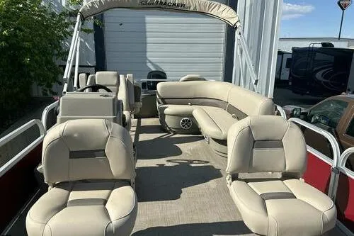 Slide: The Image of 2025 Sun Tracker Bass Buggy 18 DLX pontoon boat with beige seating and canopy. - 5
