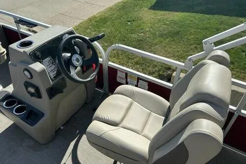 Slide: The Image of 2025 Sun Tracker Bass Buggy 18 DLX boat interior with steering console and seating. - 7