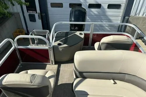 Slide: The Image of 2025 Sun Tracker Bass Buggy 18 DLX pontoon boat interior with beige seating. - 9