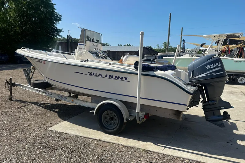 Slide: The Image of 2005 Sea Hunt Triton 186 boat on trailer with Yamaha outboard motor in sunny outdoor setting. - 10