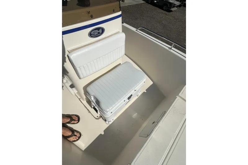 Slide: The Image of 2005 Sea Hunt Triton 186 boat interior with seating and storage. - 14
