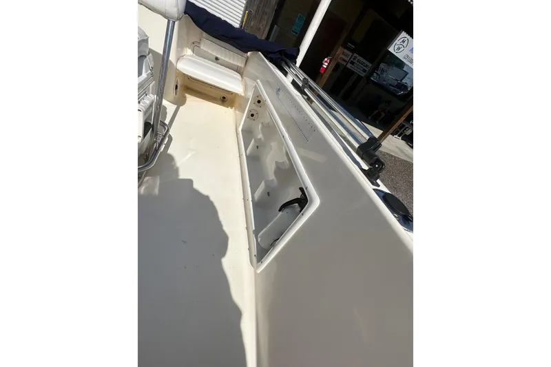 Slide: The Image of 2005 Sea Hunt Triton 186 boat interior with storage compartment and seating. - 16